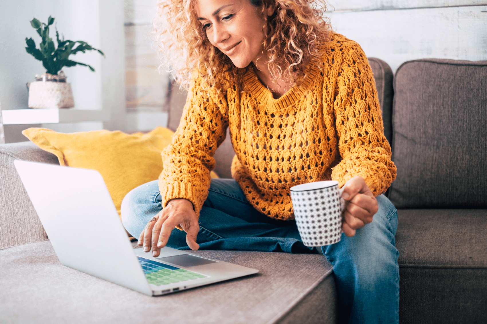 woman using her laptop on her couch
