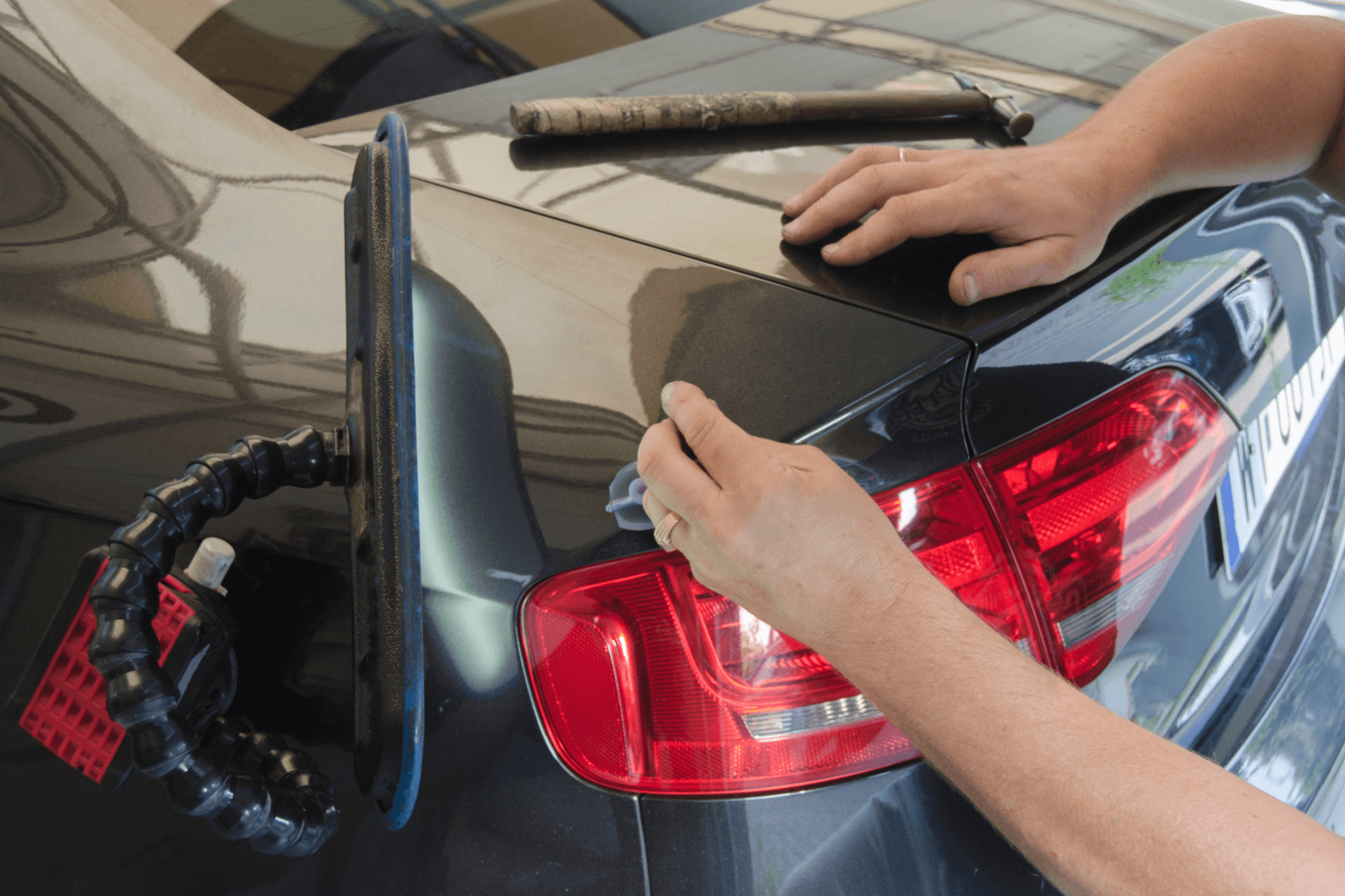 Tech working on fixing a dent on bumper