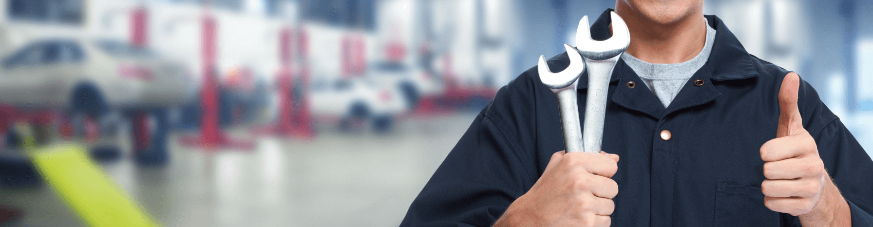 service tech with wrenches in one hand and giving thumbs up